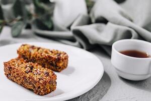 Two granola bar and tea cup photo