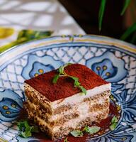 Piece of traditional italian Tiramisu dessert cake photo