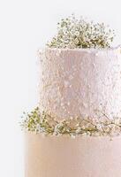 Beautiful multi-tiered wedding cake with flowers photo