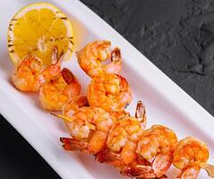 Grilled Shrimp Scampi Skewers with lemon photo