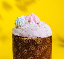 Traditional Easter cakes with meringue on yellow background photo