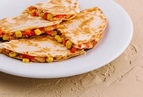 Mexican quesadilla with vegetables on plate photo
