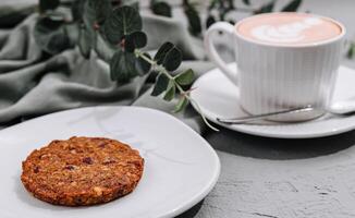 Oatmeal Cookies on White Plate and tea cup photo