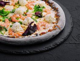 black pizza with shrimp and cream photo