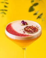 tropical cocktail with cream on yellow background photo