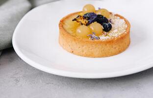 Tart with lemon curd and fresh berries photo