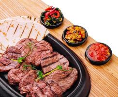 Grilled steaks and pita bread with sauce photo