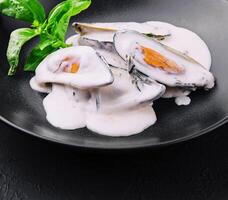 mussels in a creamy blue cheese sauce and basil photo