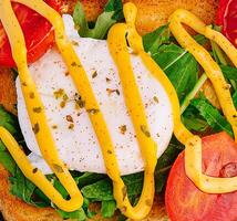 Poached egg with arugula, cherry tomatoes and toast photo