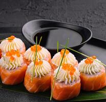 sushi rolls wrapped with salmon and caviar photo