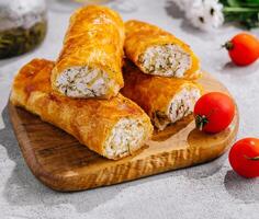 Cooking traditional pies with cottage cheese on wooden table photo