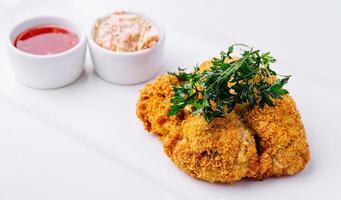 Chicken schnitzel with sauce on plate photo