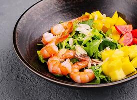 Seafood salad in ceramic bowl top view photo