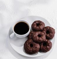 cookies in chocolate glaze with cup of coffee photo