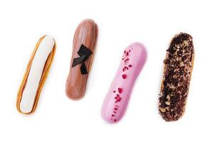 different types of French eclairs on a white background photo