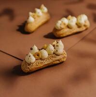 eclairs with whipped cream and hazelnuts photo