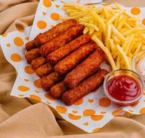 french fries with chicken nuggets and sauces photo