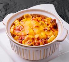 Macaroni and cheese baked on plate photo