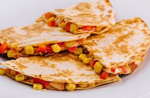 Mexican quesadilla with vegetables on plate photo