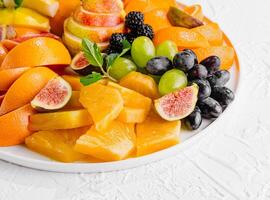 Exotic fruits platter isolated on white photo