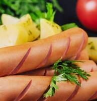 boiled sausages with potatoes closeup photo