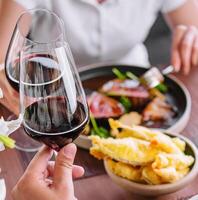 Man and woman drinking red wine in the restaurant photo