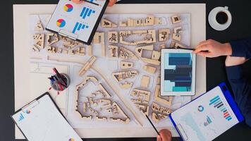 Top view of team engineering brainstrom working and discussing project plan in modern office, top view. Group of professional architects talking architectural plans for sustainable shared office space photo