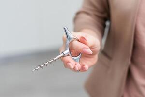 Hand holding corkscrew isolated on white background. Clipping path photo