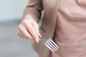 Fork in a hand on a white background isolation photo