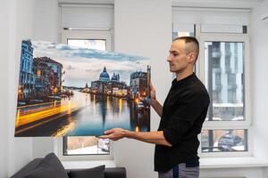 Photo canvas print. A man holding a photography with gallery wrap