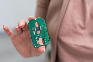 Hand holding IC chip ipod isolated on white photo
