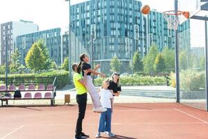 family playing basketball on court photo