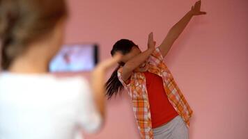 two little girls taking photo with a smartphone