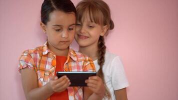 Happy little girls with a smartphone in hands communicate at home with loved ones using modern technology photo