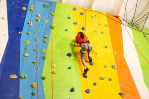 Little Girl Climbing Rock Wall photo