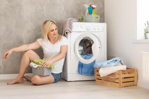 Housework, young woman doing laundry photo