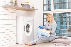 pretty smiling girl in the laundry room photo