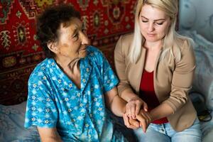 Senior woman with her home caregiver photo