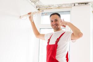 Technician of the air conditioning system is working on installing a new air conditioner in the apartment. photo