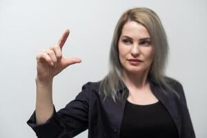 Young hispanic girl wearing casual clothes smiling and confident gesturing with hand doing small size sign with fingers looking and the camera. measure concept photo