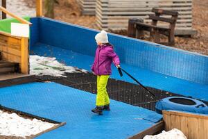 Child riding on tube, little girl during tubing in winter park photo