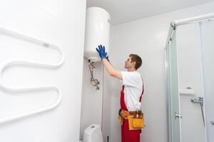 Professional engineer doing a boiler inspection at home photo