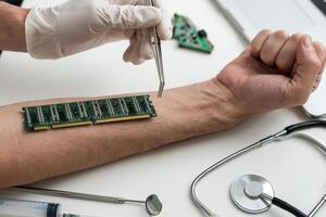 cropped view of male hand with microchip and syringe for microchipping on table photo
