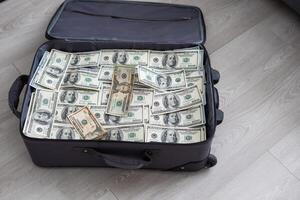 Open suitcase with one million dollars bills stacks photo