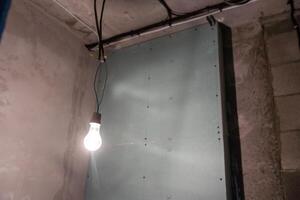 Construction materials and sheets of plasterboard or drywall are prepared for working process of installing plasterboard -drywall -for making gypsum walls in apartment is under constructi photo