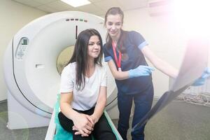 Young doctor looking at computed tomography x-ray image photo