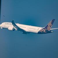 New Delhi, India, December 25 2023 - Vistara Airbus A320 neo take off from Indra Gandhi International Airport Delhi, Vistara domestic aeroplane flying in the blue sky during day time photo