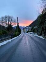 a road with a sunset in the background photo