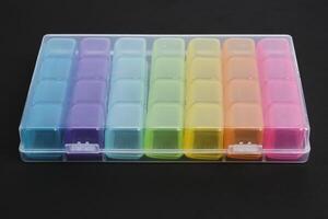 Pill organizer that distributes intake by day of the week. photo