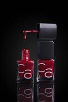 two bottles of red nail polish photo